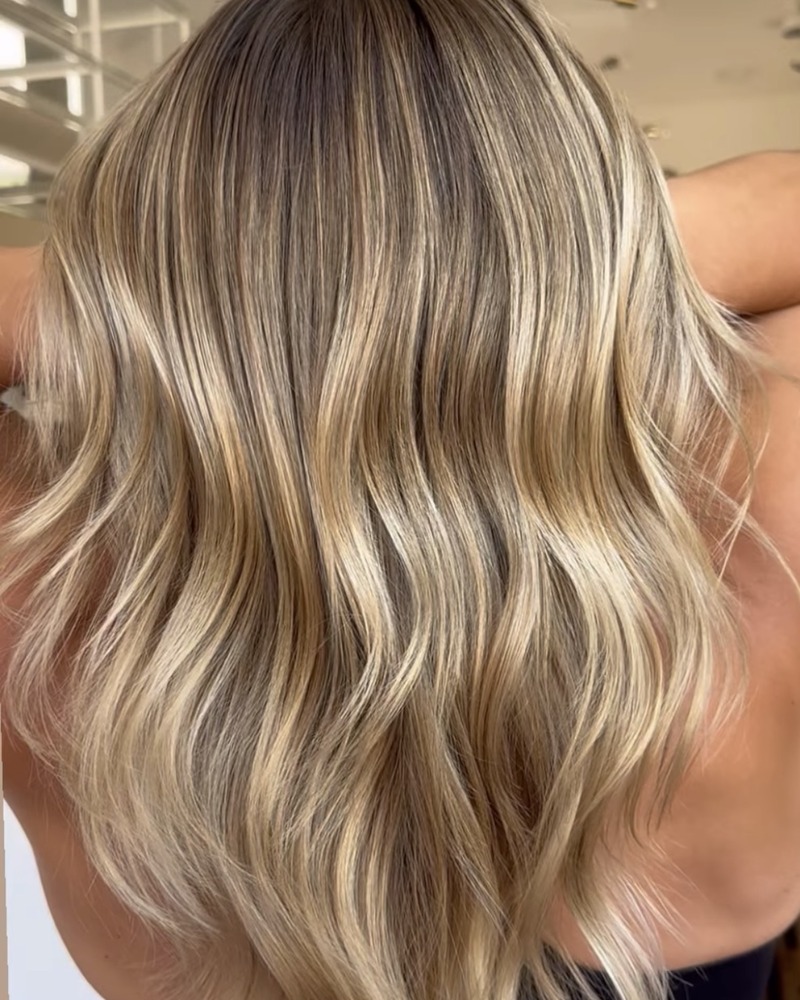 Hand-painted balayage with soft blonde dimension at Rise Above Beauty Lounge in Colorado Springs