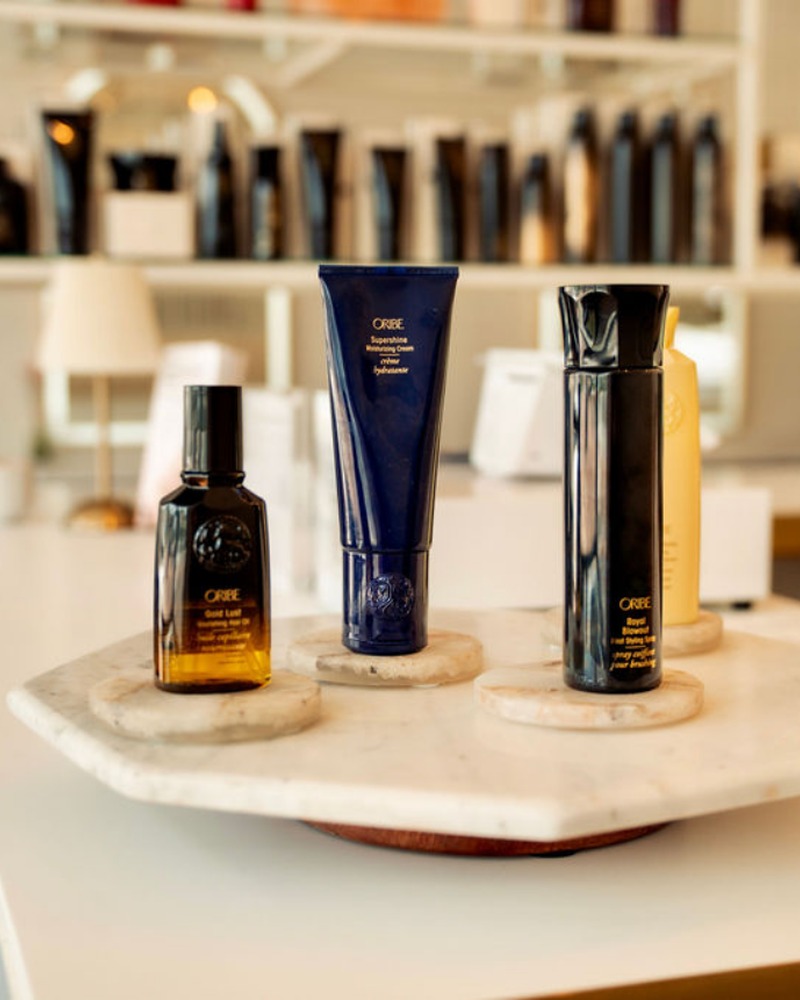 Oribe products arranged on a marble tray at Rise Above Beauty Lounge